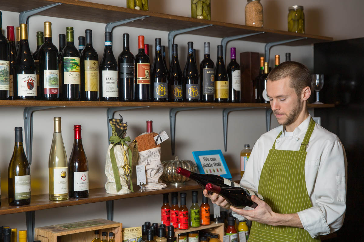 Man choosing wine for customer